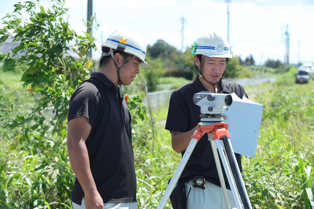 測量機器を使い現場を確認する富士実業のスタッフ